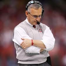 Ohio State Head Football Coach Jim Tressel on sidelines arms crossed head down
