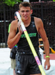 Armand Duplantis with pole on his shoulder preparing to jump.